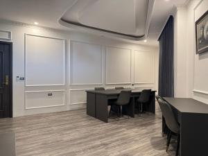 a conference room with a table and black chairs at Sen plaza Hotel in Yên Thành +13 photos