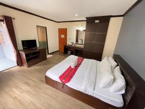a bedroom with a large white bed with a television at Emporium Chiangmai in Chiang Mai +27 photos