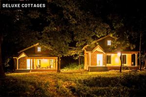 a house lit up at night with lights at Green Nest Resorts in Malebennūr