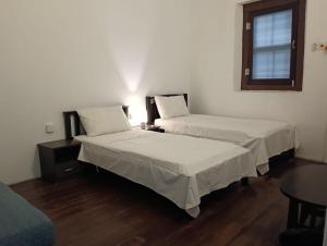 a room with two beds and a table and a window at 24 Kimberley in George Town +33 photos