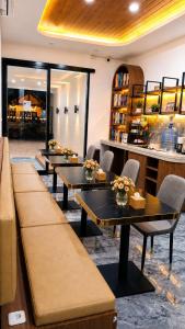 eine Reihe von Tischen in einem Restaurant mit Blumen darauf in der Unterkunft Moshi Moshi in Probolinggo