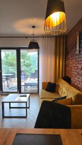 a living room with a couch and a table at Loft Apart View & Wellness in Szczyrk