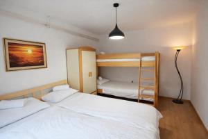 a bedroom with two beds and a bunk bed at Hiša Žičanka in Loče pri Poljčanah
