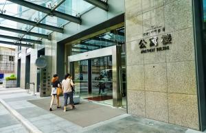 two people walking in front of a building at East Station Boya Hotel in Guangzhou