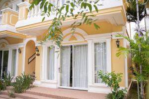 a yellow house with a large glass door at Sokchea Kampot Hotel in Kampot +138 photos