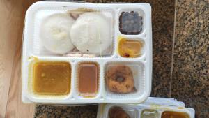a plastic container filled with food on top of a counter at La town beach stay in Pondicherry