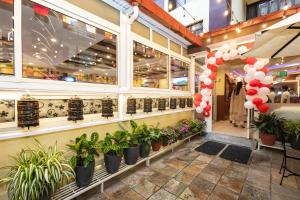 a store front with potted plants and balloons at Aryatara Kathmandu Hotel in Kathmandu
