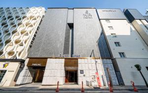 a building on a street with orange cones in front of it at 호텔 어게인 in Cheongju