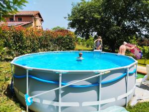 a group of people in a pool in a yard at Gite La Saubolle à Marciac in Marciac