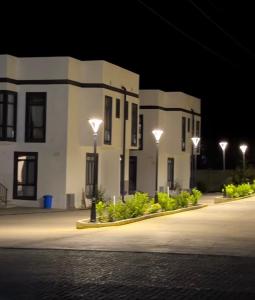 a building with lights in front of it at night at Townhouse Atlantis Resort in Chetkoysu