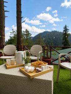 a table with a tray of food on a patio at The Cozy Cottage, Dunga Gali in Dunga Gali