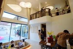 a group of people in a room with a restaurant at Villa Mar Pool Villa in Sathani Hat Yai +118 photos