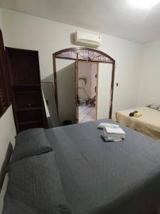 a bedroom with a bed and a mirror at durmaaquislz2 in São Luís
