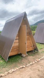 a large wooden building with a pitched roof at Aluoi Homestay in Hue +10 photos
