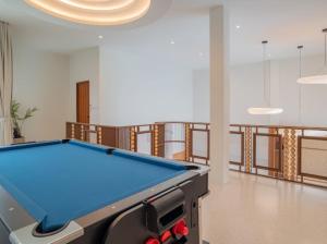 a pool table in the middle of a room at Villa Mar Pool Villa in Sathani Hat Yai