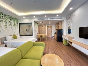 a hotel room with two beds and a couch at FLC Sea Tower Quy Nhơn - View Biển in Quy Nhon