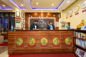 a bar in a restaurant with two people sitting at a counter at Aryatara Kathmandu Hotel in Kathmandu