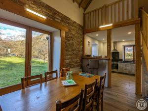 a dining room and kitchen with a table and chairs at Le castillon in Marignac