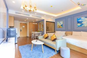 a living room with a bed and a couch at FLC Sea Tower Quy Nhơn - View Biển in Quy Nhon
