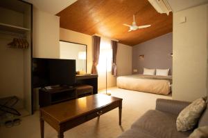 a hotel room with a bed and a couch at Hotel Karuizawa Elegance in Karuizawa