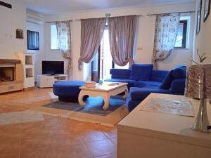 a living room with a blue couch and a table at Apartments F&A in Split