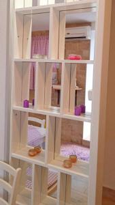 a book shelf with someones shoes in it at Apartments F&A in Split +59 photos