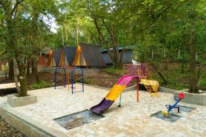 a playground with a slide and a slide at Rain Forest Jungle Stay in Kurandi