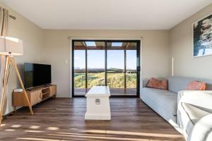 a living room with a couch and a tv at Six-Ten Shores in Dolphin Sands