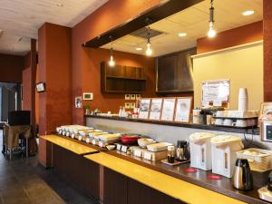 a kitchen with a counter with food on it at KOKO HOTEL Himeji Castle in Himeji