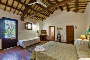 a bedroom with two beds and a table in it at Anastè in Buseto Palizzolo