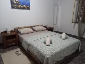 a bedroom with two beds with towels on them at Kuca za odmor Maestral in Privlaka