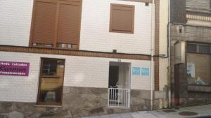 a building with an open door on a street at Casa Carmen 1 in Cudillero