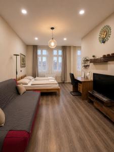 a bedroom with two beds and a desk and a television at Kael Apartment in Teplice
