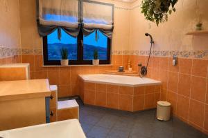 a bathroom with a tub and a window at Ferienwohnung Am Wäldchen in Vöhl