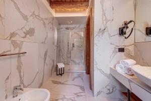 a bathroom with a toilet sink and a shower at Hotel Rosa delle Alpi in Esino Lario +35 photos