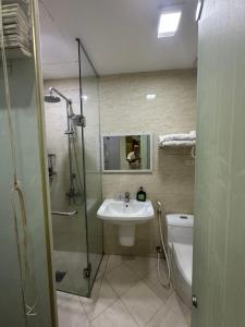 a bathroom with a shower and a sink and a toilet at Hanoi Better Hotel & spa in Hanoi