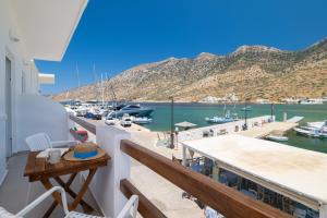 a balcony with a view of a marina at Aurum Suites Sifnos in Kamares