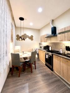 a kitchen with a table and chairs in a kitchen at Kael Apartment in Teplice