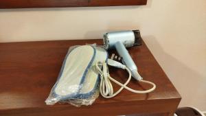 a hair dryer on a table with a blow dryer at Voyager's Villa in Habarana