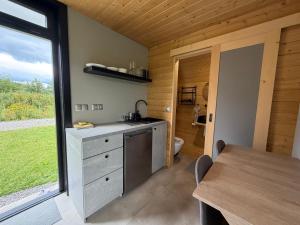 a kitchen with a sink and a table and a window at Tatry Panorama House in Zuberec