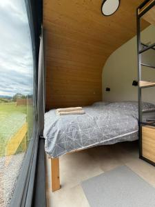 a bed in a small room with a window at Tatry Panorama House in Zuberec