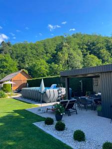 a patio with a table and a boat on it at Lauras Ferienwohnung - Ihre Wohlfühloase in der Südweststeiermark mit Garten, Pool, Biotop & Weinbar in Eibiswald