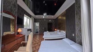 a bedroom with three beds and a piano at ESAL House in Karakol