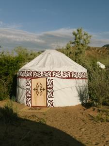 a yurt in the middle of a dirt field at Urban Monkey Summer Camp in Kaji-Say