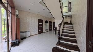 a hallway with a staircase in a house at ESAL House in Karakol