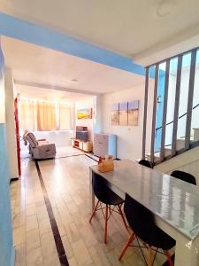 a large living room with a table and chairs at Paraiso La Mata in La Mata