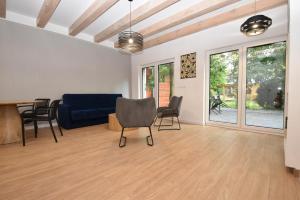 a living room with a blue couch and chairs at Turawski Zakątek in Turawa