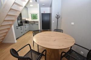 a kitchen with a wooden table and chairs in a room at Turawski Zakątek in Turawa +13 photos