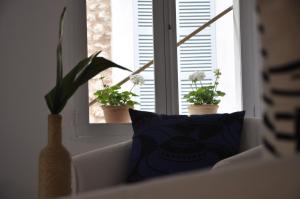 a window with two potted plants on a window sill at Ecocirer Guest House in Sóller