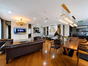 a living room with a couch and a table at Poshtel 56 in Bangkok